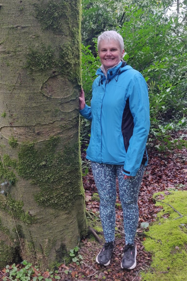 Michelle Doyle standing by a tree in nature